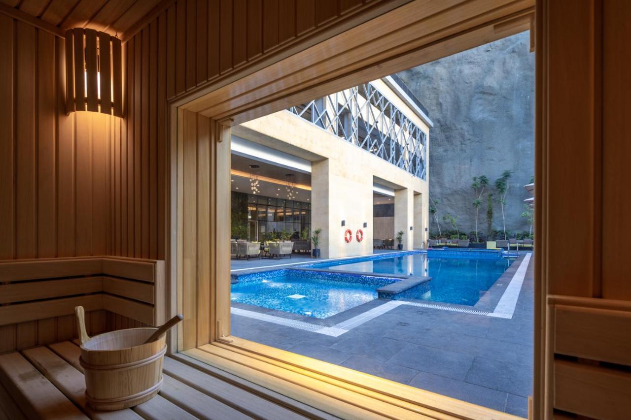 Citadines Abha Aparthotel Exteriör bild The swimming pool at the hotel